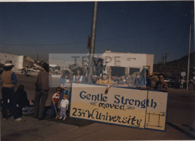 Gentle Strength Co-op Demolition View of Sign and Crowd