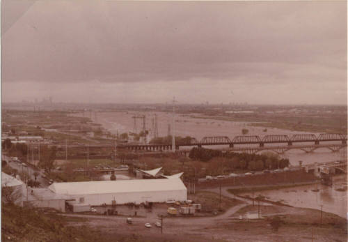 Flooded Salt River with Mill Avenue Bridge, Railroad Bridge, and Ash Avenue Bridge facing west