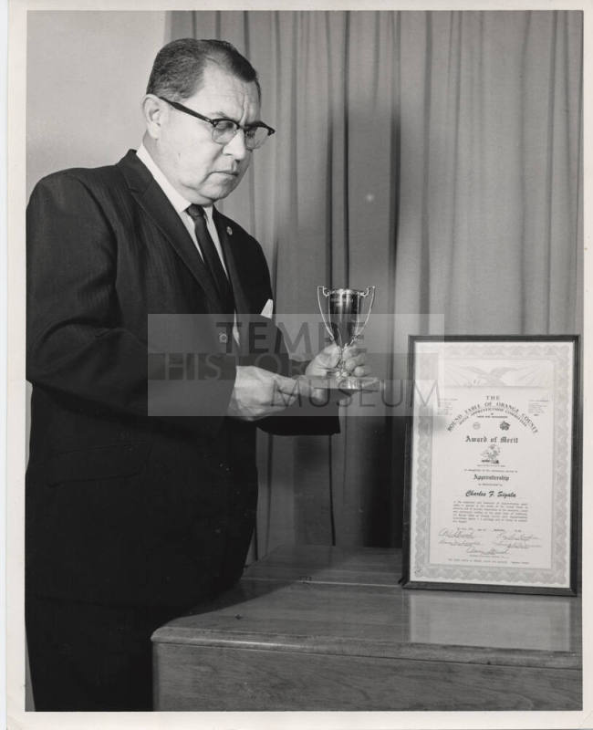Charles Sigala Holding a Trophy, ca 1963