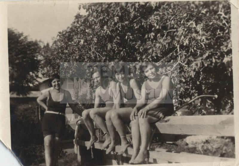 Four people in swimming suits.