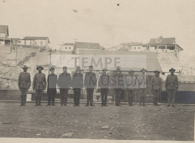 Men in the National Guard standing in a mining town