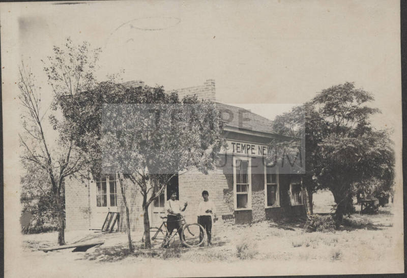 Chris Sigala and another person in front of the Tempe News building