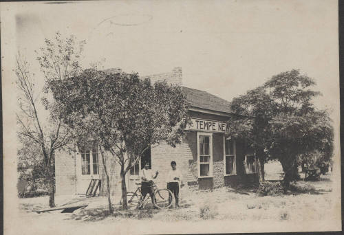 Chris Sigala and another person in front of the Tempe News building