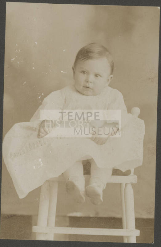 Baby boy seated in chair