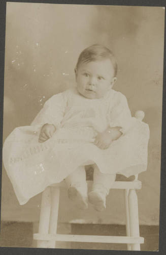 Baby boy seated in chair