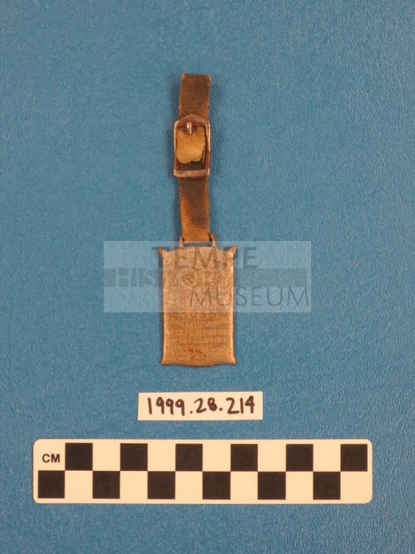 Metal fob on a leather strap