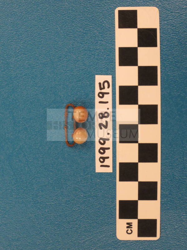 Metal clip with two buttons attached