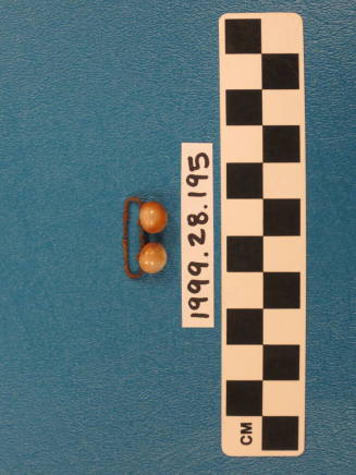 Metal clip with two buttons attached