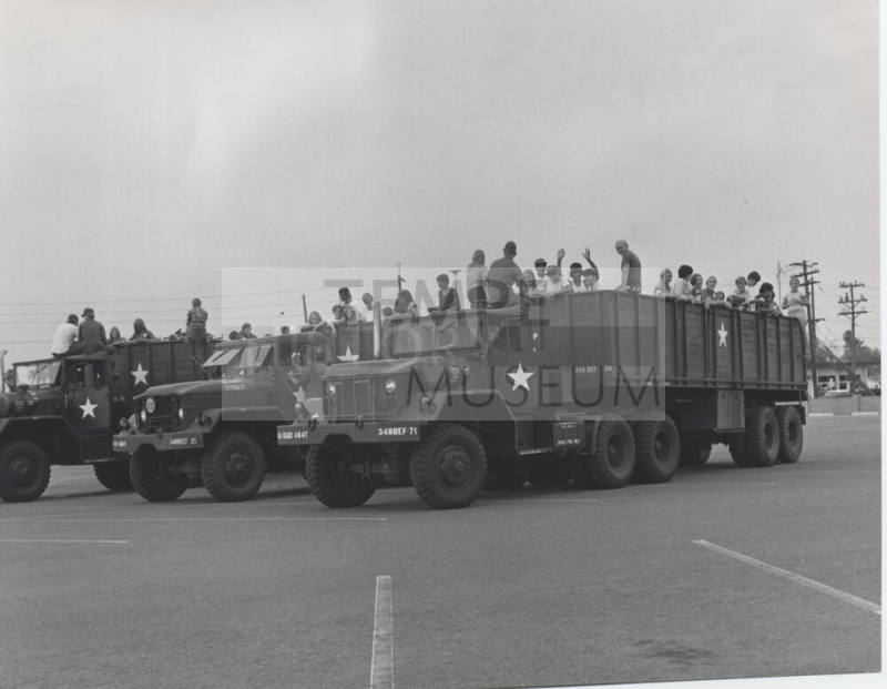 Young People in the Back of Military Transport Vehicles