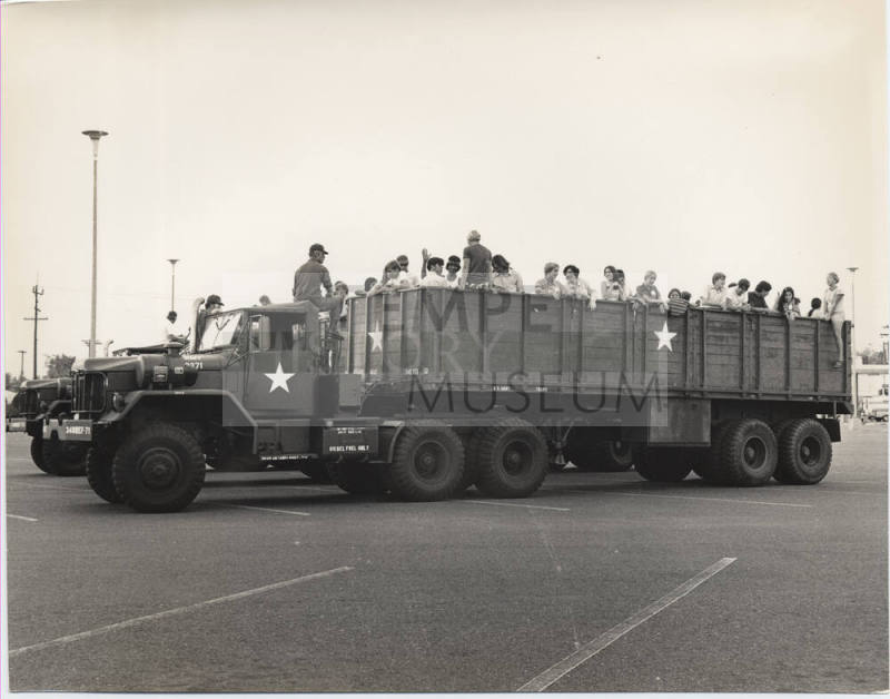 Young People in the Back of Military Transport Vehicles