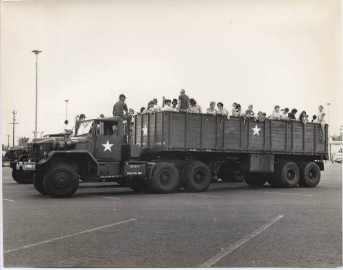 Young People in the Back of Military Transport Vehicles