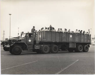 Young People in the Back of Military Transport Vehicles