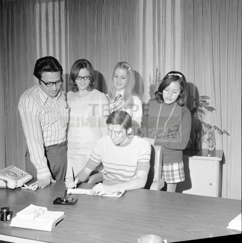 5 people at signing of document