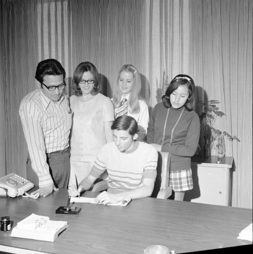 5 people at signing of document