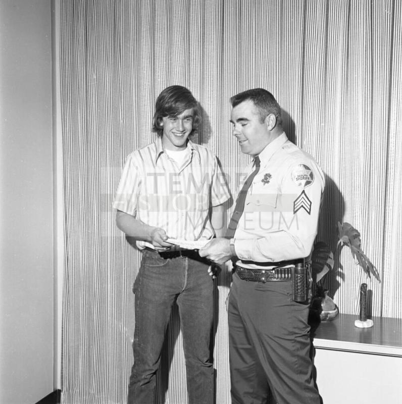 Sheriff Presents Paper to teen