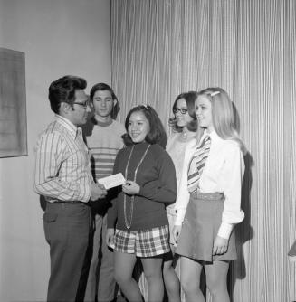 Five people, one receiving paper