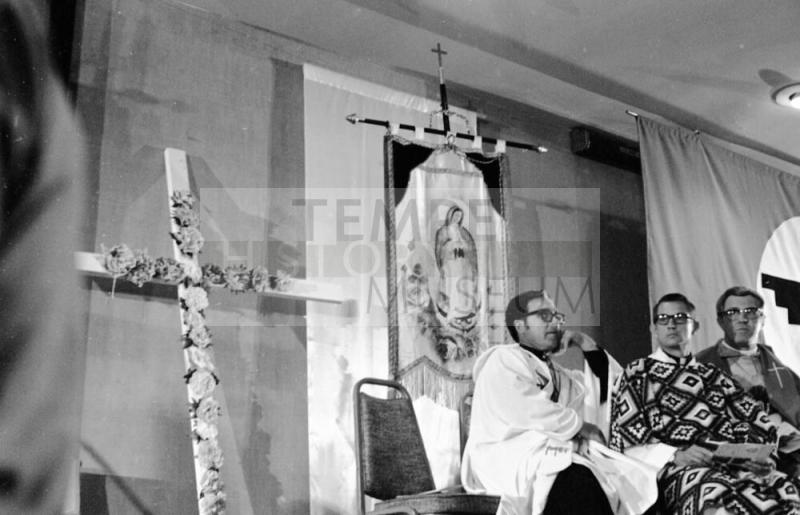 Cross, Virgin Mary, and Priests at Chavez's Fast Breaking Mass