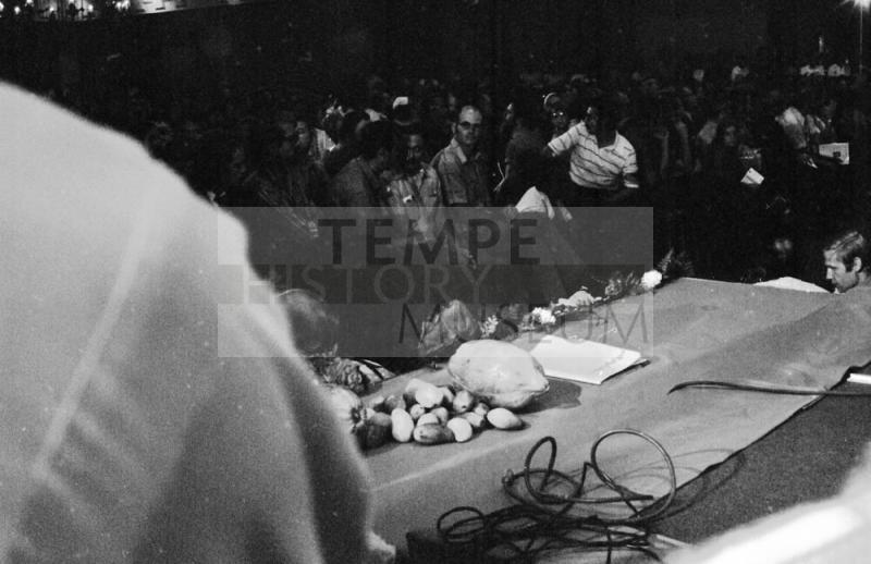Chavez Fast Breaking Mass: Symbolic Farm Produce on Podium Edge
