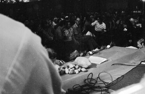 Chavez Fast Breaking Mass: Symbolic Farm Produce on Podium Edge