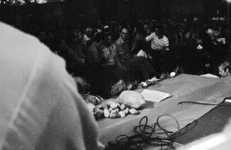 Chavez Fast Breaking Mass: Symbolic Farm Produce on Podium Edge