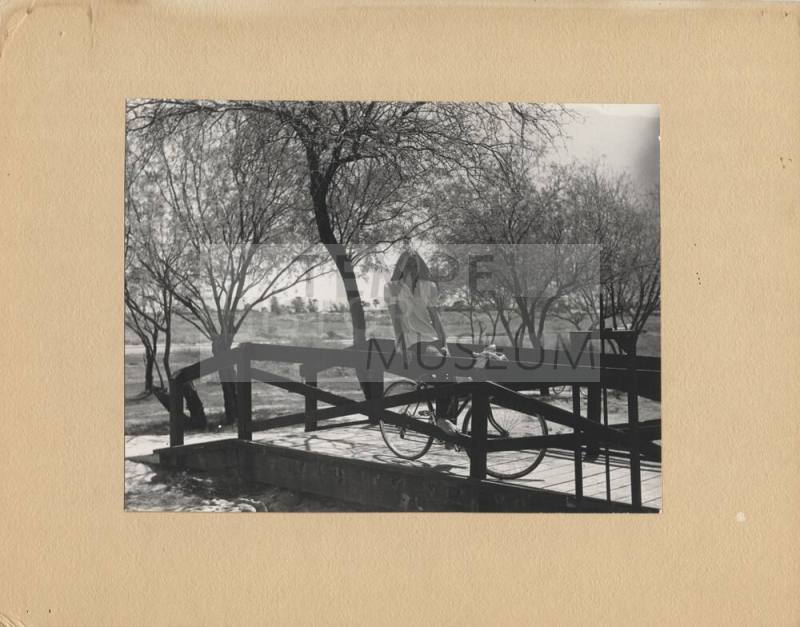 Woman and Bike on a Small Bridge