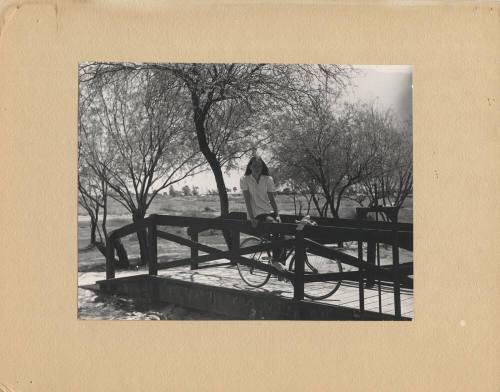 Woman and Bike on a Small Bridge