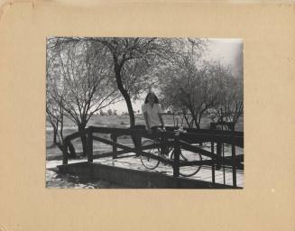 Woman and Bike on a Small Bridge