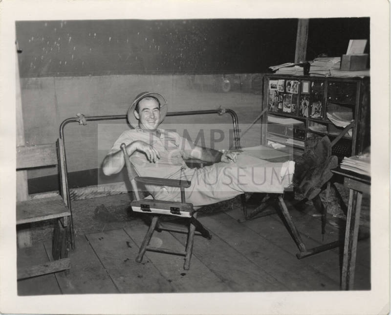 Man in Work Clothes in director chair
