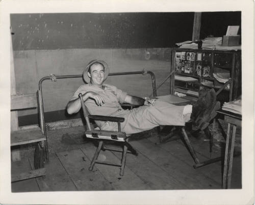 Man in Work Clothes in director chair
