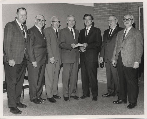 Group photo presenting check