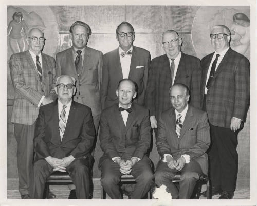 Two rows of men in suits