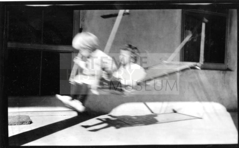 Image of two children in hammock