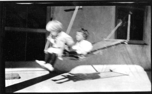 Image of two children in hammock