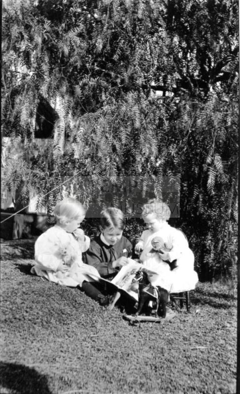 Image of three children with toys