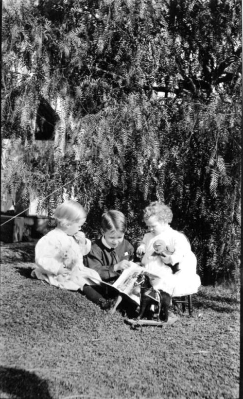 Image of three children with toys