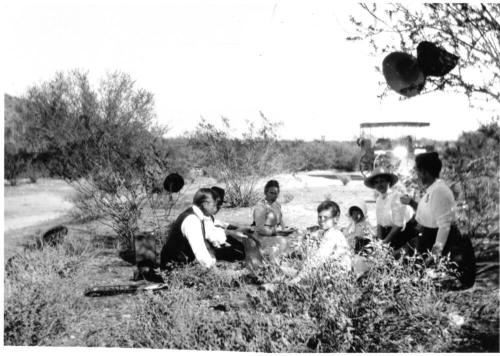 Image of a picnic in the desert with the Woolf family