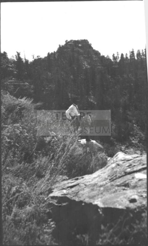 Charles Custis and Charles Howard Woolf standing on a rock ledge