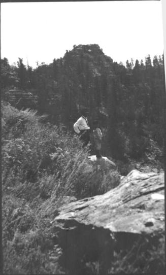Charles Custis and Charles Howard Woolf standing on a rock ledge