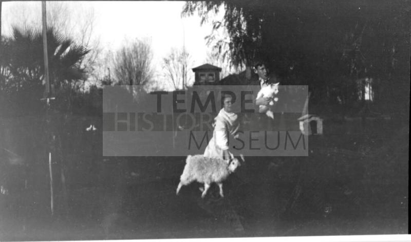 Image of Charles Harold and Dorothy holding sheep and cat.