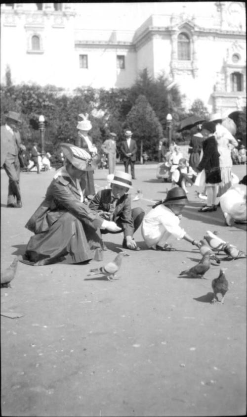 Ruby, Charles Howard, and Dorothy feeding pigeons