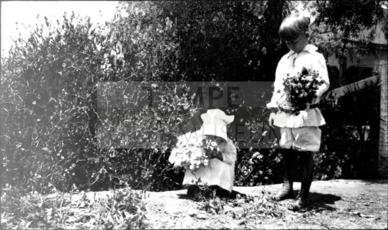 Charles Harold and Dorothy picking flowers