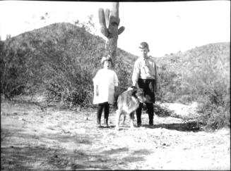 Dorothy and Charles Harold with dog in the desert