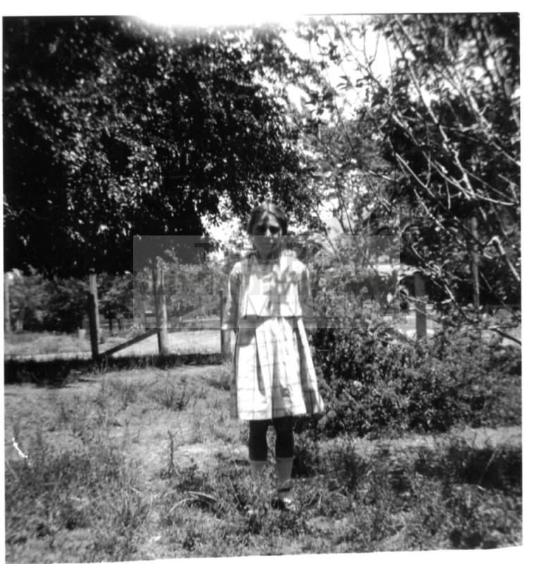 Image of unknown girl standing outdoors