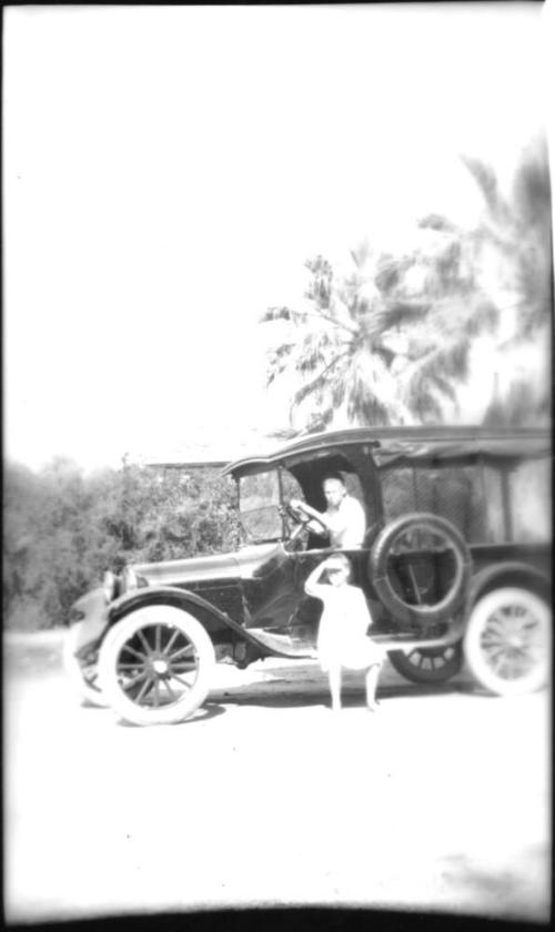 Charles Custis and Dorothy Woolf posing with car