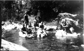 Charles Harold, Dorothy and other children playing and bathing in stream