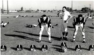 Photograph of Tempe Union Football Players Surrounded by Empty Helmets
