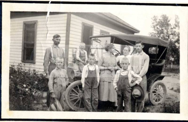 Family Photograph infront of their house and model A car