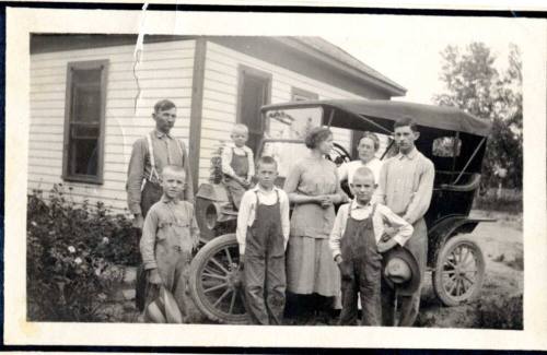 Family Photograph infront of their house and model A car