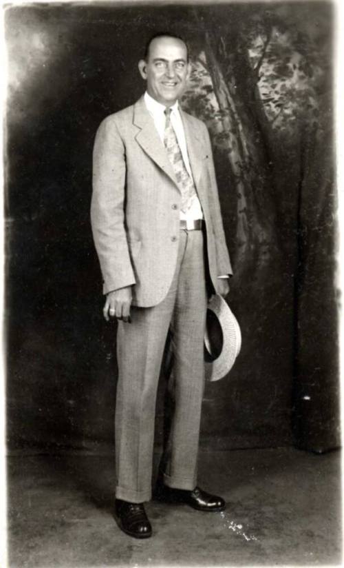 Portrait of William Laird in a suit holding a hat