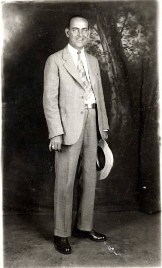 Portrait of William Laird in a suit holding a hat